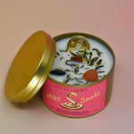 The Year of the Snake Intention & Manifestation Candle - Chinese Zodiac Candle on a pink background with the lid off leaning against the container.