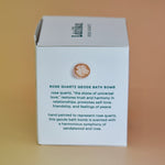 The side of the Rose Quartz Crystal Bath Bomb box on a pink background.