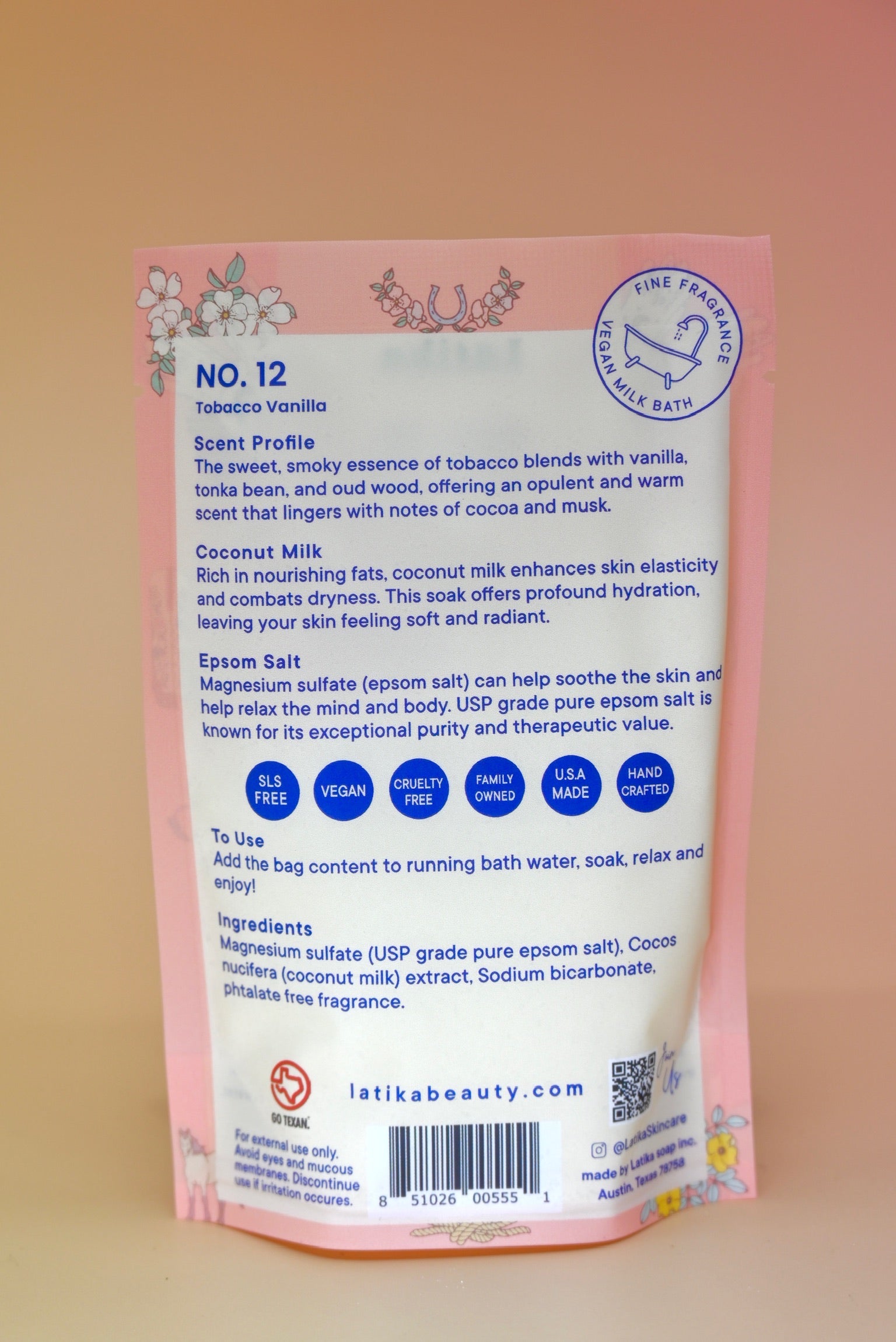 The back of the Tobacco-Vanilla Vegan Bath Soak on a dusty pink background.