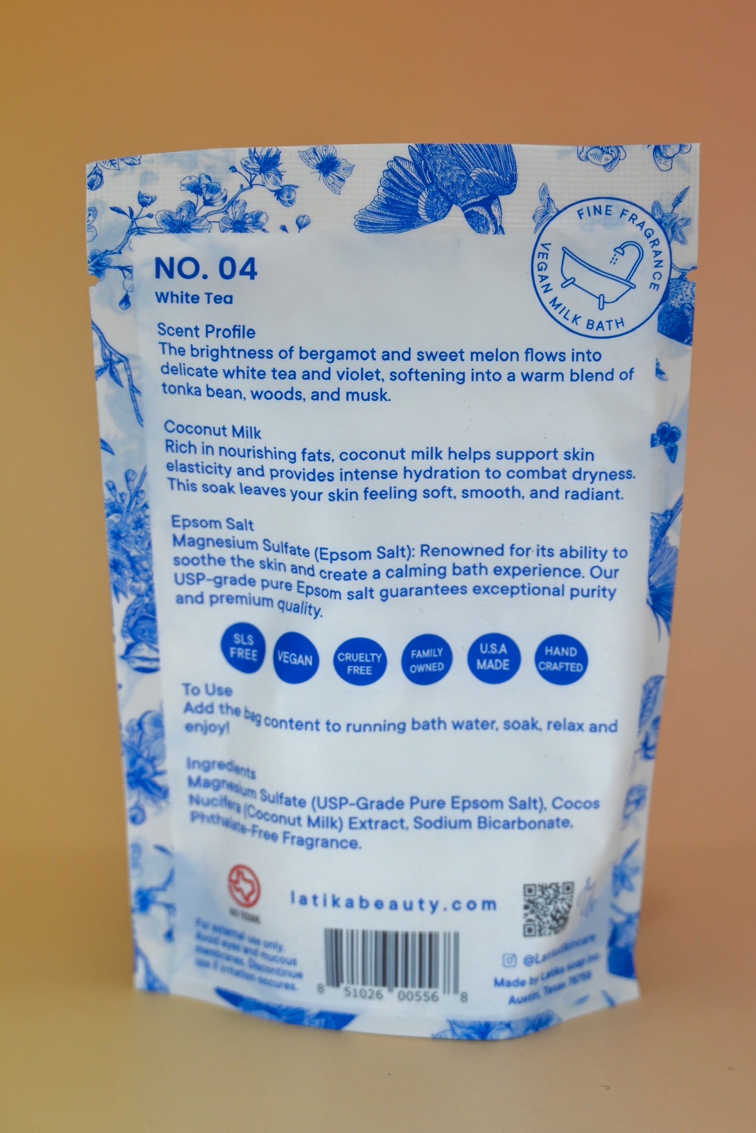 The back of the White Tea Milk Bath Soak on a dusty pink background.