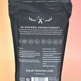 The back of the Black Hatchet Shower Steamers - Grapefruit & Mint Shower Steamers on a pink background.
