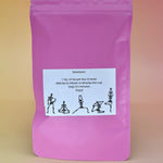 The  back of the Touch of Earl Grey Loose Tea Blend on a pink background.
