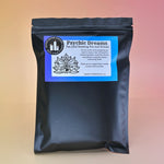 The Psychic Dreams Tea Leaf Reading and Ritual Kit on a pink and yellow background.