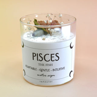 The Pisces Zodiac Crystal Candle on a peach colored background.