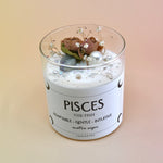 The Pisces Zodiac Crystal Candle on a peach colored background.