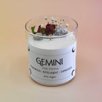 The Gemini Zodiac Crystal Candle on a peach colored background.