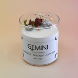 The Gemini Zodiac Crystal Candle on a peach colored background.