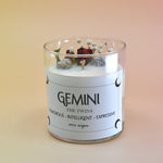 The Gemini Zodiac Crystal Candle on a peach colored background.