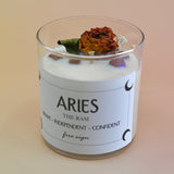 The Aries Zodiac Crystal Candle on a peach colored background.