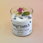 The Sagittarius Zodiac Crystal Candle on a peach colored background.