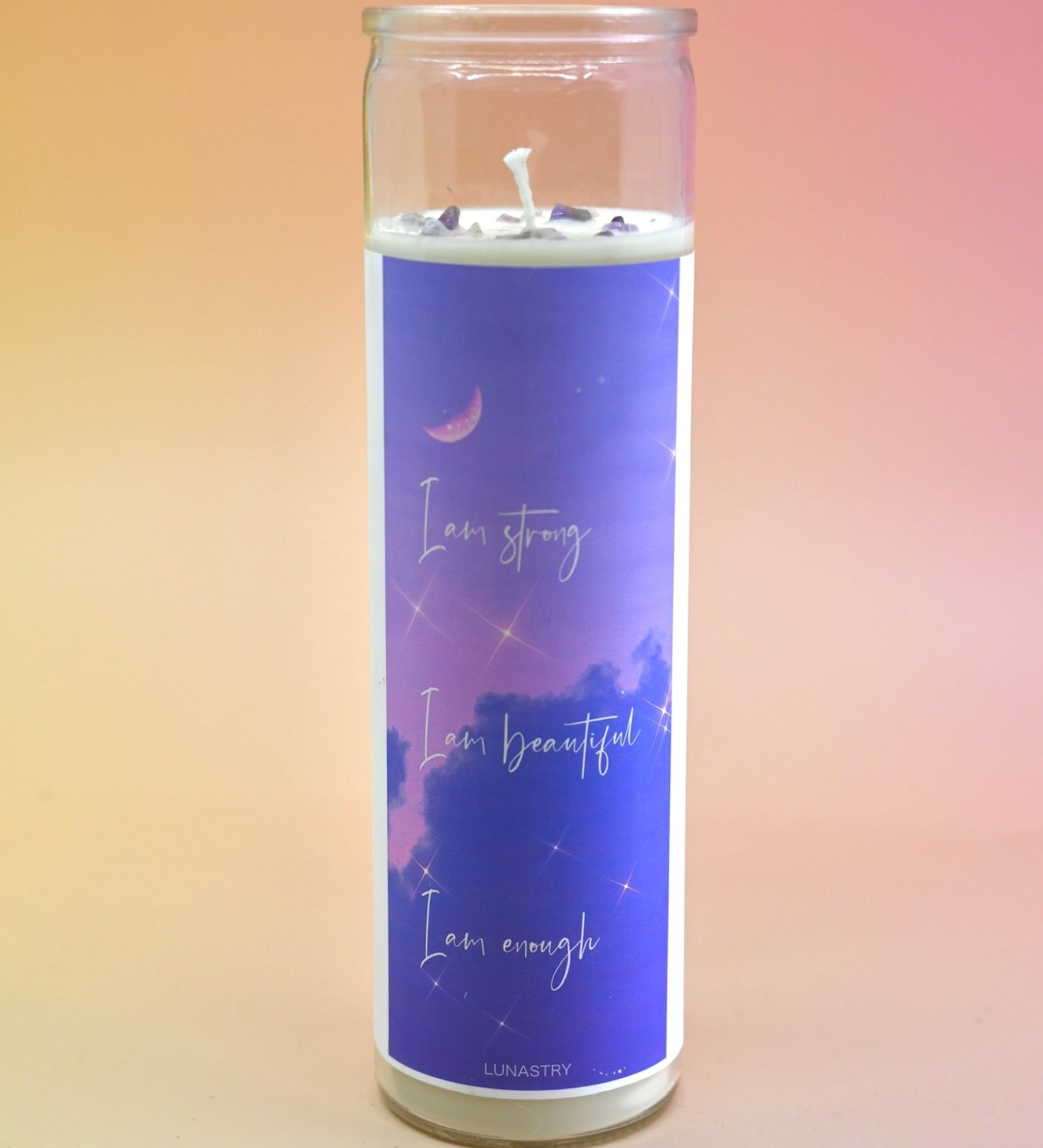 The "I am Strong" Prayer Candle on a pink and yellow background.