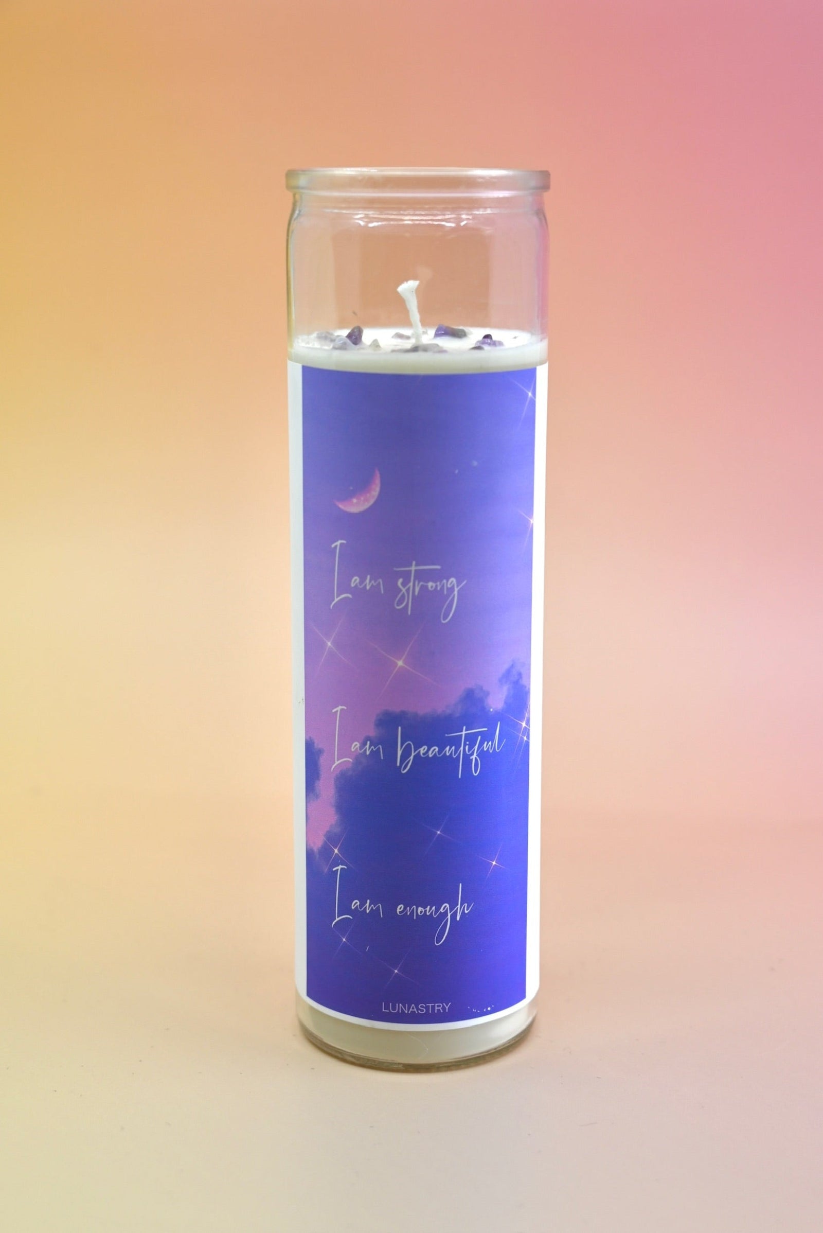 The "I am Strong" Prayer Candle on a pink and yellow background.