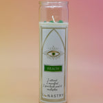 The Wealth Soy-Wax Prayer Candle on a pink and yellow background.