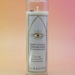 The Protection Prayer Crystal Candle on a pink and yellow background.