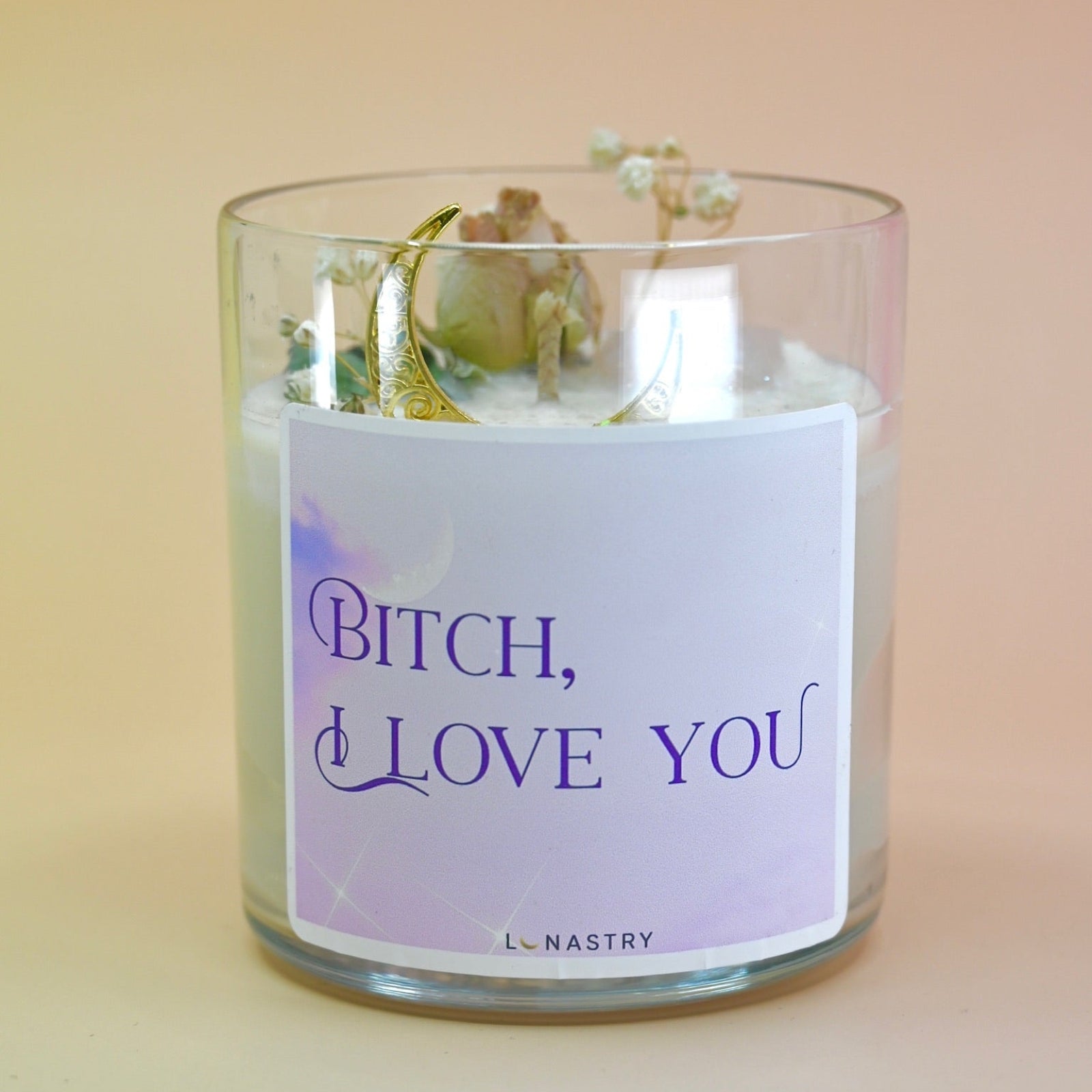 The "Bish, I love you" Candle - Floral and Crystal Candle on a peach-colored background.