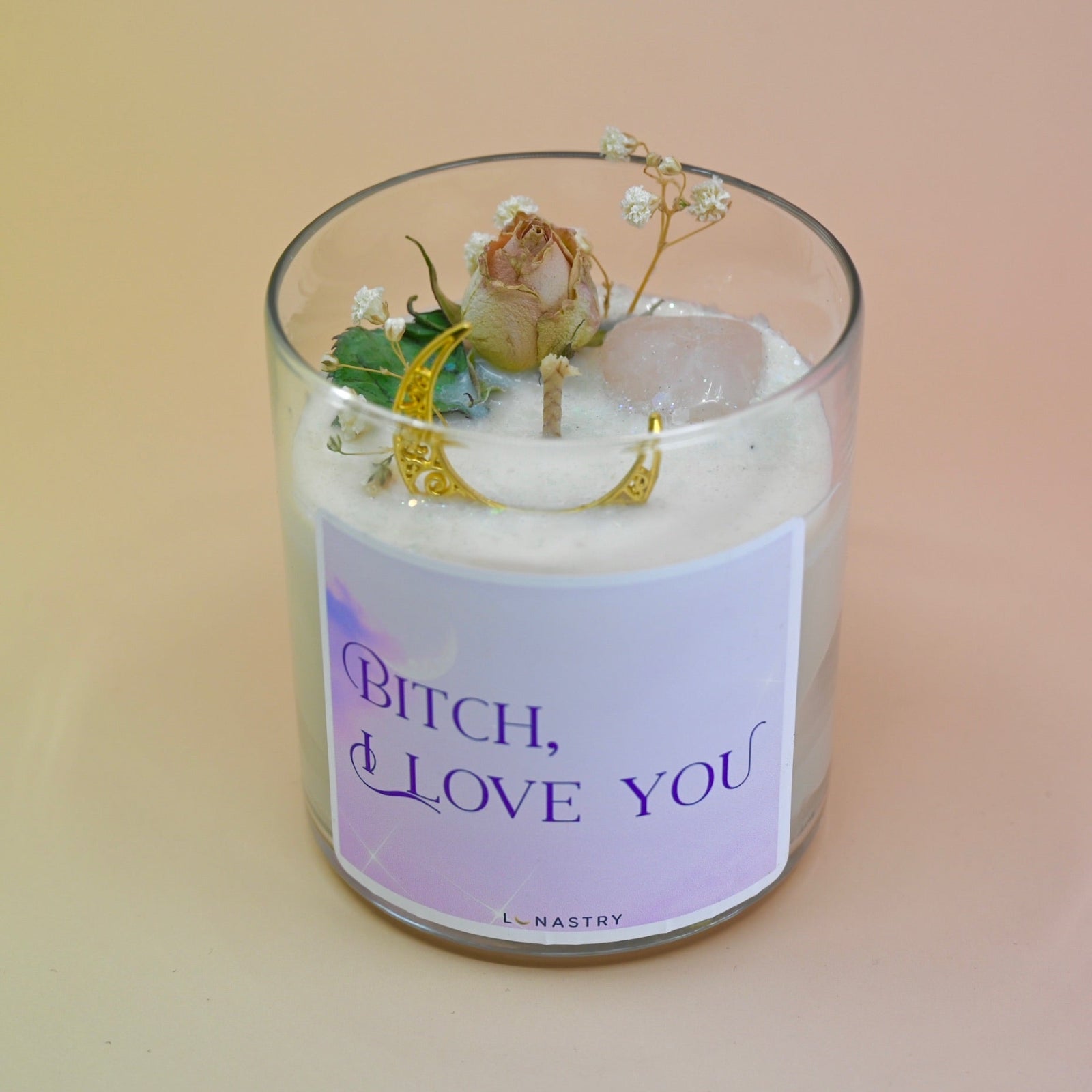 The "Bish, I love you" Candle - Floral and Crystal Candle on a peach-colored background.