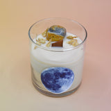 The Moonchild Crystal Candle on a pink background.