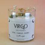 The Virgo Zodiac Crystal Candle on a peach colored background.