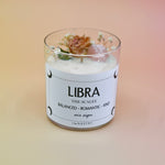 The Libra Zodiac Crystal Candle on a peach colored background.