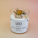 The Leo Zodiac Crystal Candle on a peach colored background.