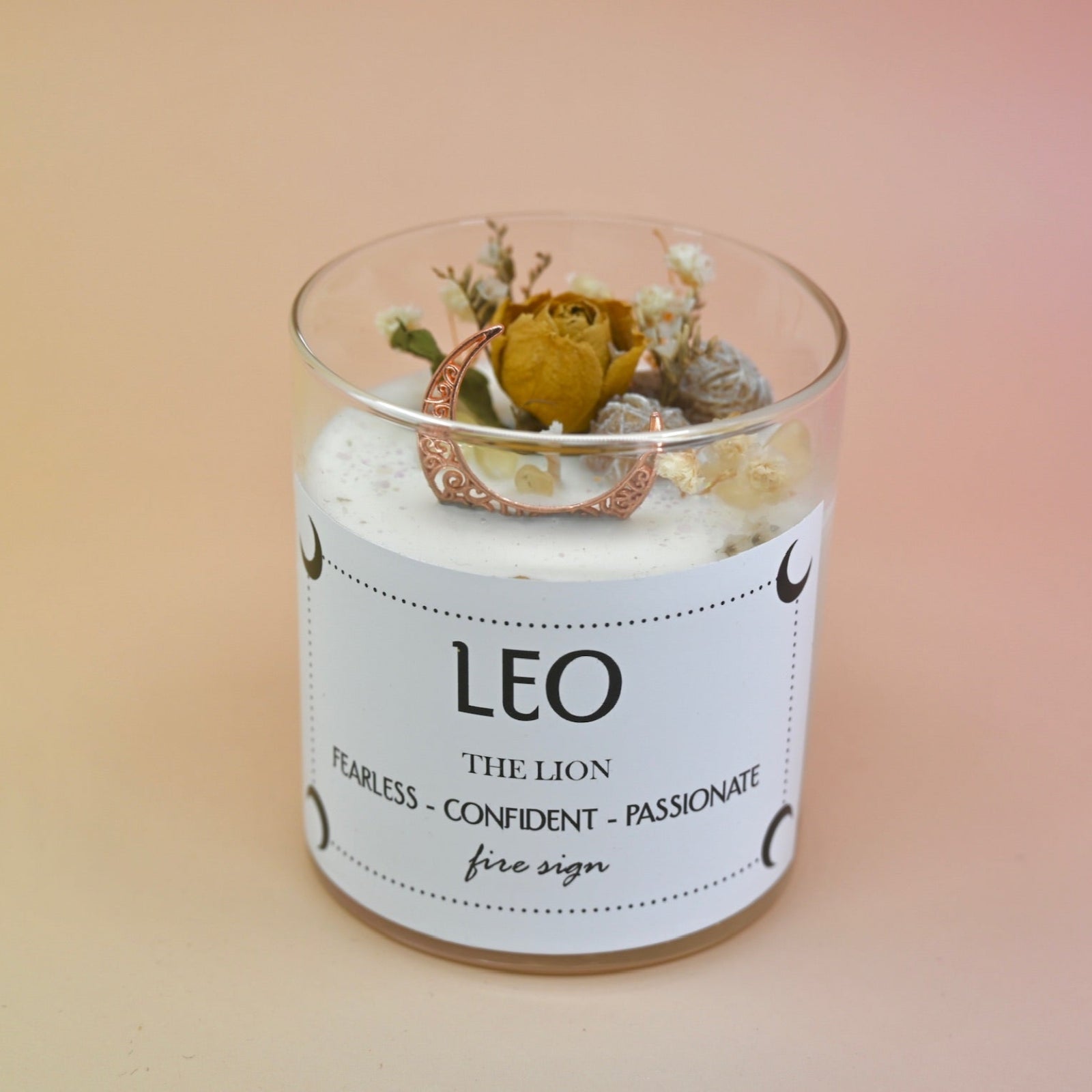 The Leo Zodiac Crystal Candle on a peach colored background.