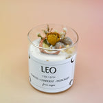 The Leo Zodiac Crystal Candle on a peach colored background.