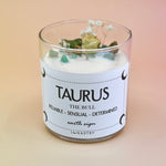 The Taurus Zodiac Crystal Candle on a peach colored background.