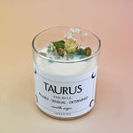 The Taurus Zodiac Crystal Candle on a peach colored background.