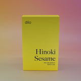 The Hinoki Sesame 50ml Unisex Eau de Parfum box on a pink background.