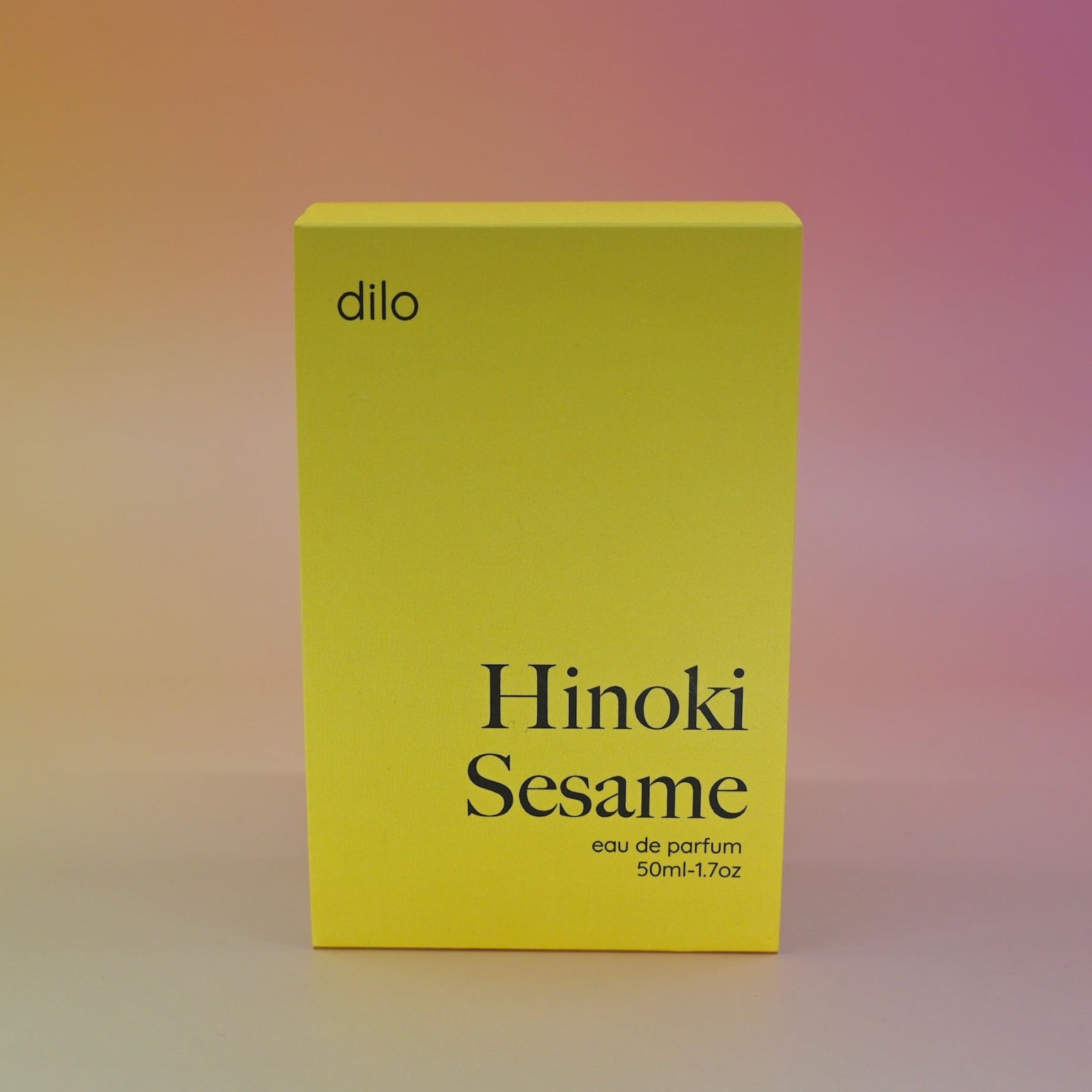 The Hinoki Sesame 50ml Unisex Eau de Parfum box on a pink background.