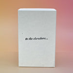 The back of the dilo perfume box on a light pink background.