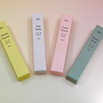 All of the travel sprayer dilo perfumes on a light pink background.