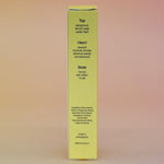 The back of the box of the Hinoki Sesame 5ml Unisex Eau de Parfum Travel Sprayer on a pink and yellow background.