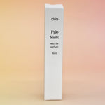 The box of the Palo Santo 15ml Unisex Eau de Parfum Travel Sprayer on a light pink background.