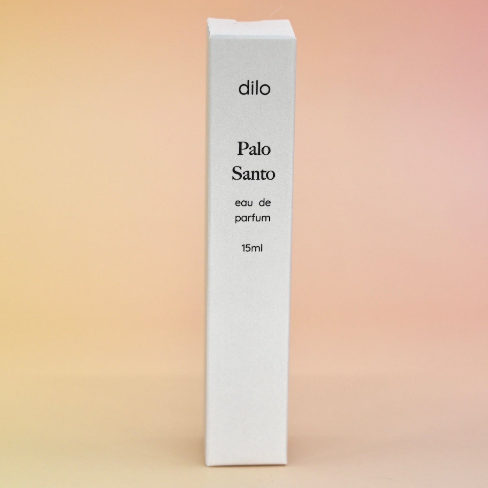 The box of the Palo Santo 15ml Unisex Eau de Parfum Travel Sprayer on a light pink background.