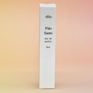 The box of the Palo Santo 15ml Unisex Eau de Parfum Travel Sprayer on a light pink background.