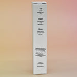 The back of the box of the Palo Santo 15ml Unisex Eau de Parfum Travel Sprayer on a light pink background.