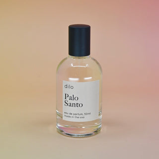The Dilo Palo Santo 50ml Unisex Eau de Parfum on a light pink background.