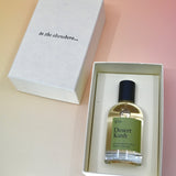 The Dilo Desert Kush 50ml Unisex Eau de Parfum in its box on a light pink background.