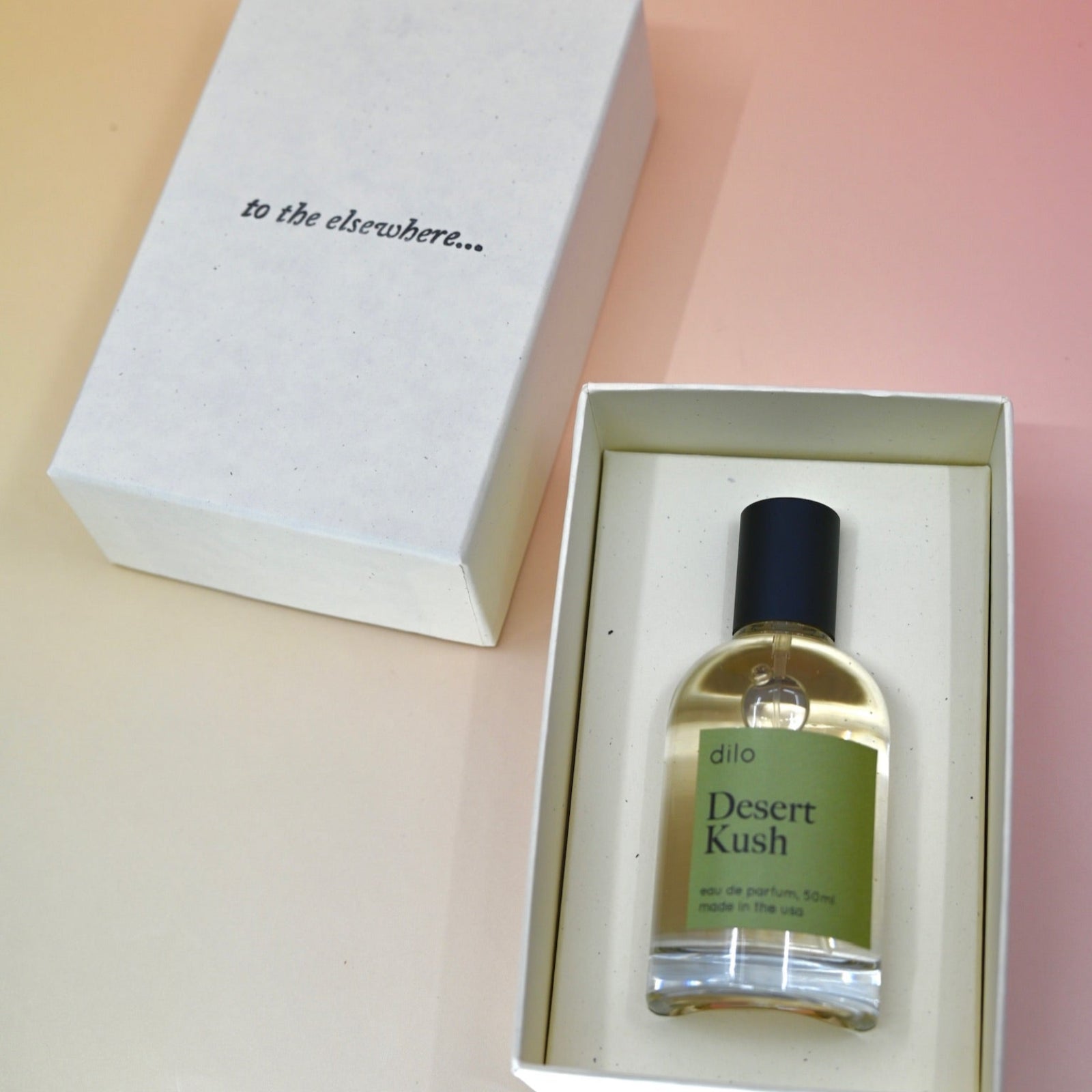 The Dilo Desert Kush 50ml Unisex Eau de Parfum in its box on a light pink background.