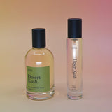 The Desert Kush 15ml Unisex Eau de Parfum Travel Sprayer and regular sized bottle on a light pink background.