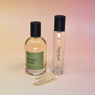 The Desert Kush 15ml Unisex Eau de Parfum Travel Sprayer and regular sized bottle on a light pink background.