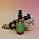 The No. 13 Vanilla Sweet Grass Room Spray in front of a dried flower bundle on a pink background.