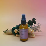The No. 09 Nag Champa Room Spray in front of a dried flower bundle on a pink background.