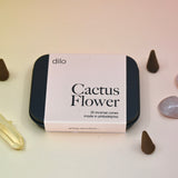 The Cactus Flower Incense Cones - Pack of 25 tin on a light pink background surrounded by crystals and incense cones.