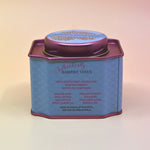 The back of the Coconut Kiss Bath Soak surrounded by crystals and dried flowers on a light pink background.