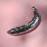 Decorative disco ball shaped like a banana on a pink background