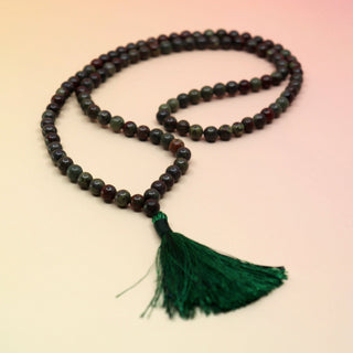 Dragonsblood 108 Mala Necklace on pink and orange background