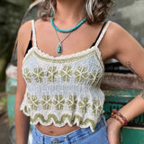 Model wearing embroidered cotton-linen crop tank top with green floral detail and scalloped hem
