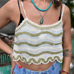 Model wearing embroidered cotton-linen crop tank top with green floral detail and scalloped hem close up view